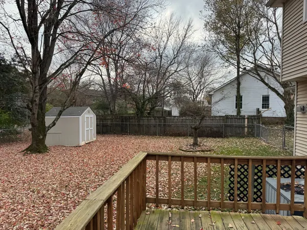 a view of a houses with yard and trees
