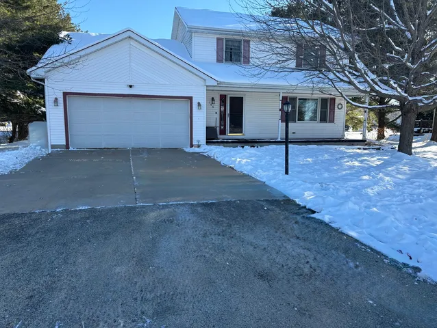 a view of a house with a yard and garage