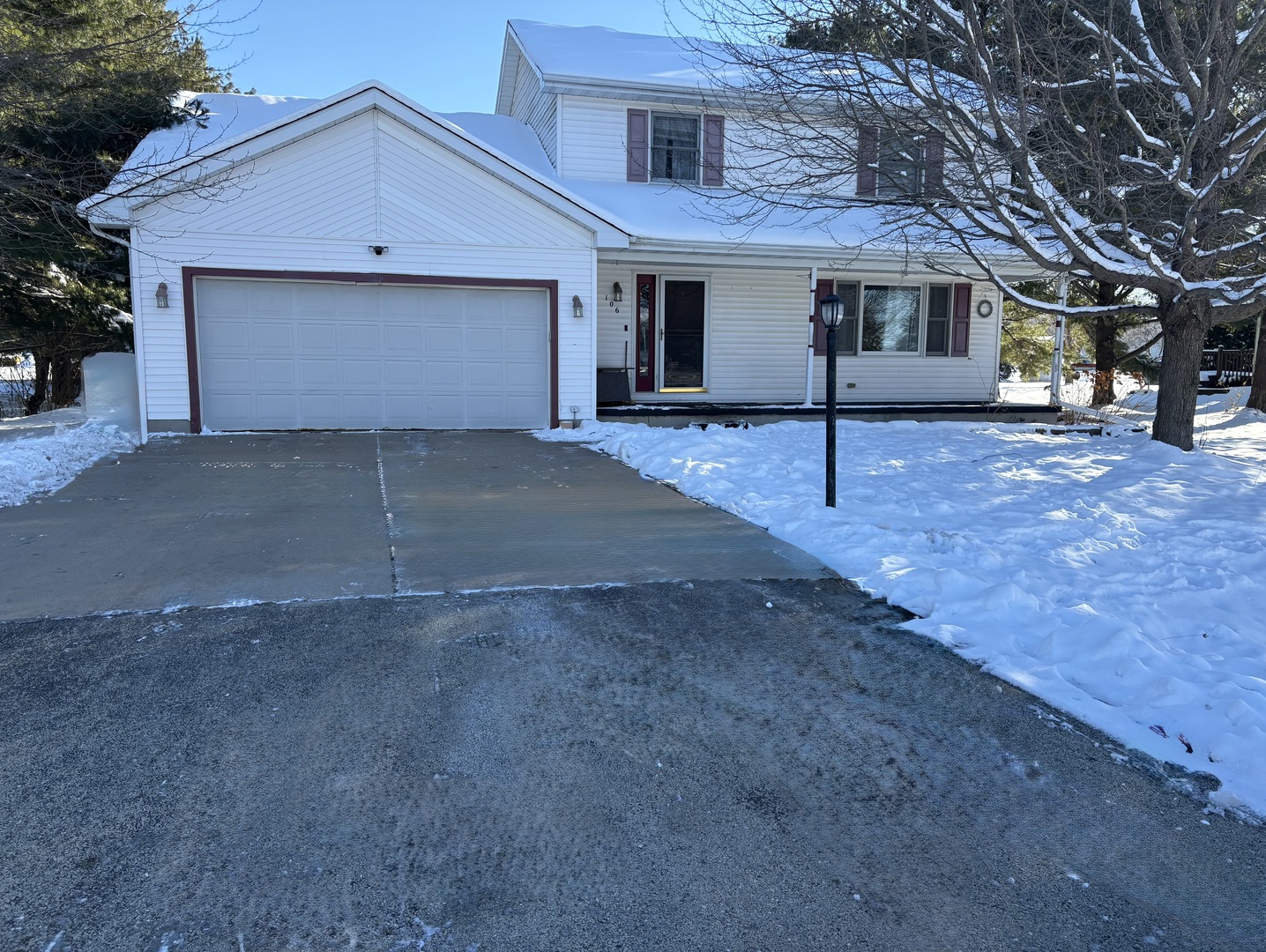 a view of a house with a yard and garage