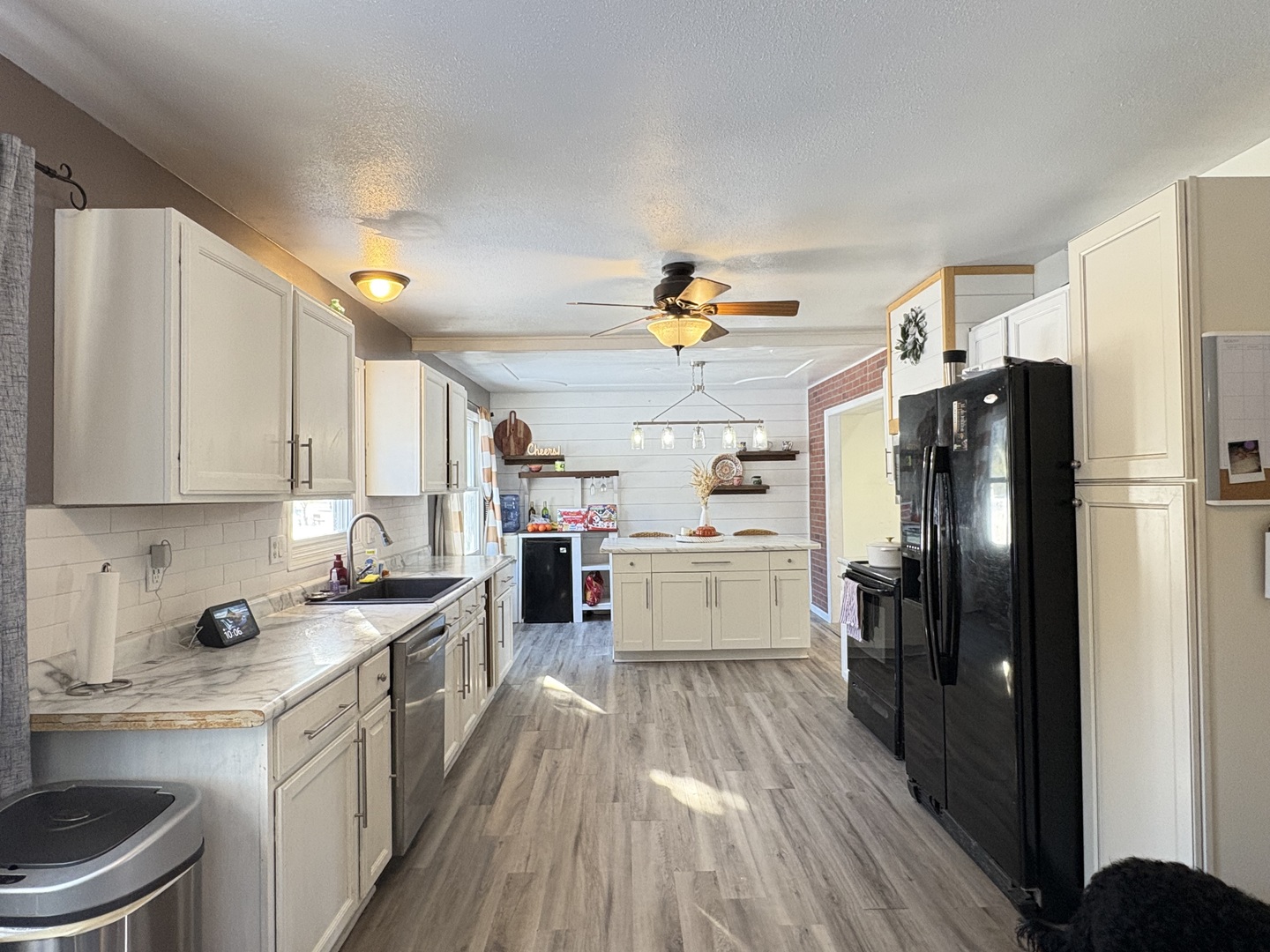 106 Windward Lane Rochelle, IL 61068 - Photo 15 of 42 a kitchen with a refrigerator a sink dishwasher and a stove with wooden floor