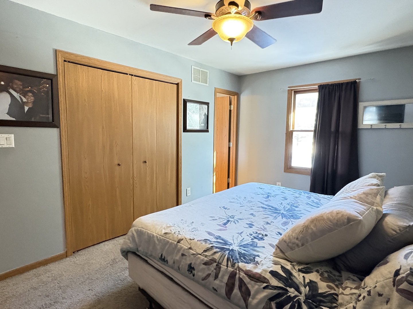 106 Windward Lane Rochelle, IL 61068 - Photo 23 of 42 a bedroom with a bed and a chandelier