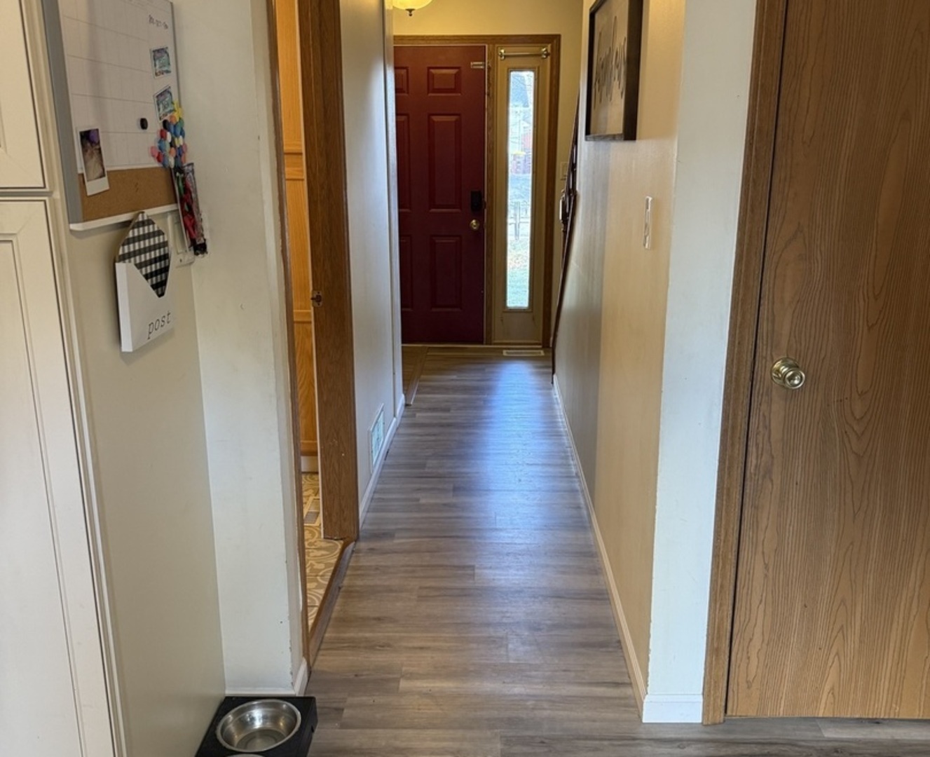 106 Windward Lane Rochelle, IL 61068 - Photo 9 of 42 a view of a hallway with wooden floor and stairs