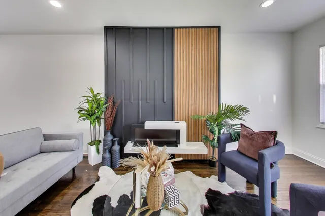 a living room with furniture potted plant and a potted plant