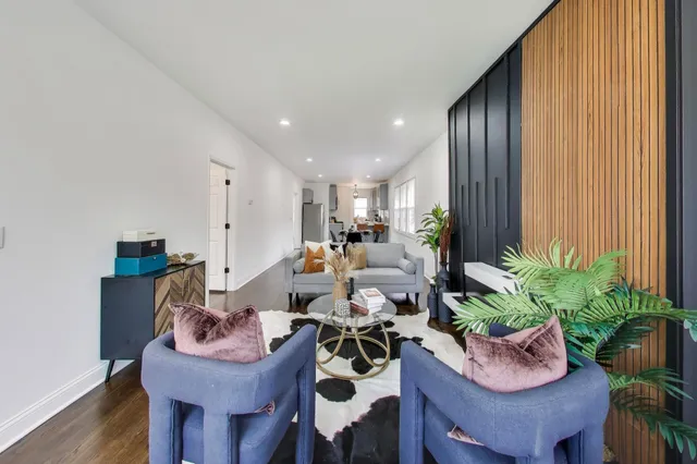 a living room with furniture and a potted plant
