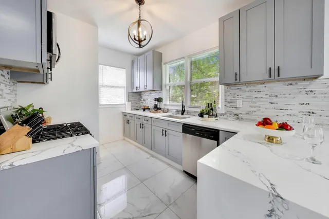 a kitchen that has a sink and a stove in it