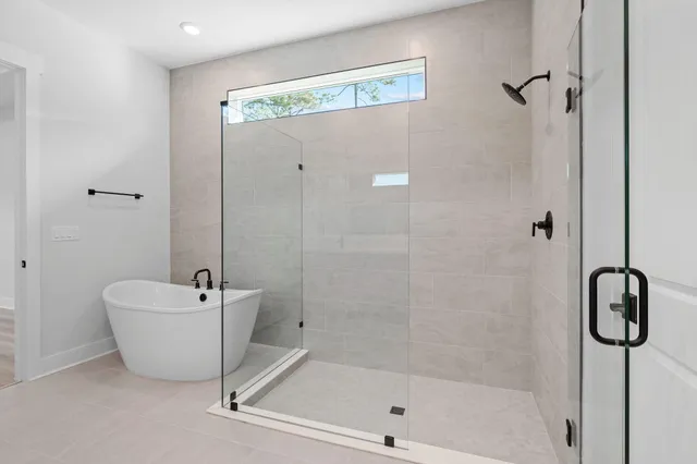 a bathroom with a bathtub and shower