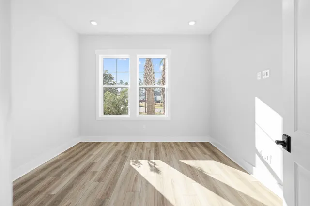 a view of a room with wooden floor and window
