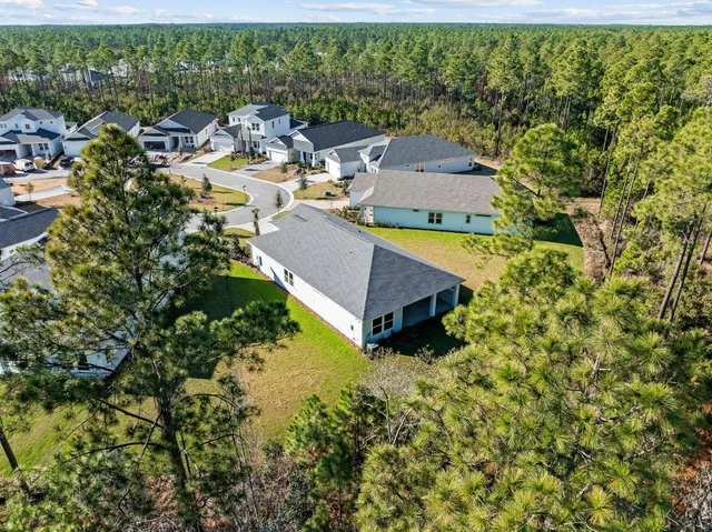 an aerial view of a house with a lake view