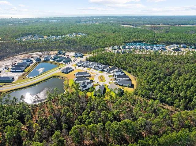 an aerial view of a house with outdoor space and a lake view