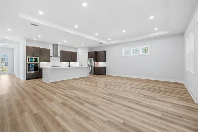 a view of a kitchen with a sink and a refrigerator