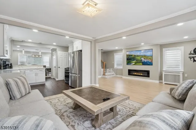 a living room with furniture and a open to kitchen