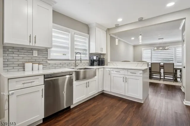 a kitchen with a sink window and cabinets