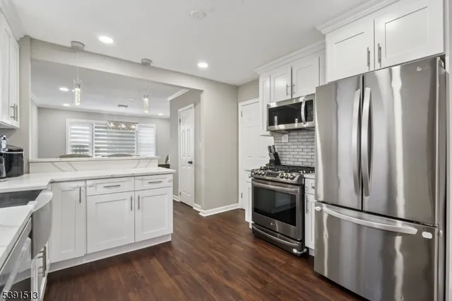 a kitchen with stainless steel appliances a refrigerator sink and stove