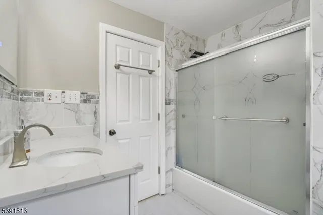 a bathroom with a sink and shower