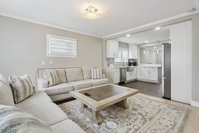 a living room with furniture and kitchen view