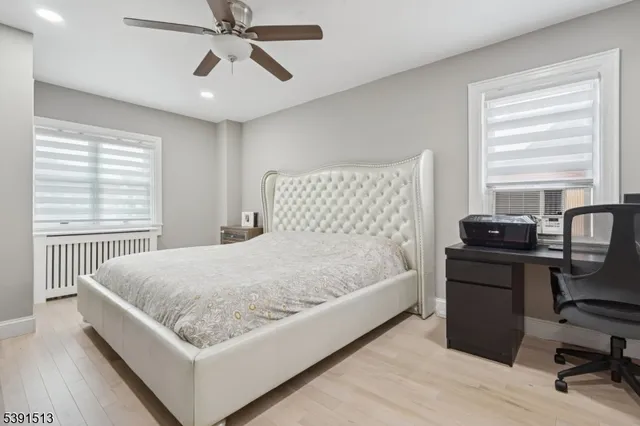 a bed sitting in a bedroom next to a window
