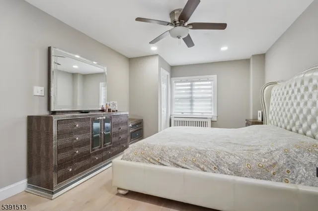 a bedroom with a large bed and a chandelier