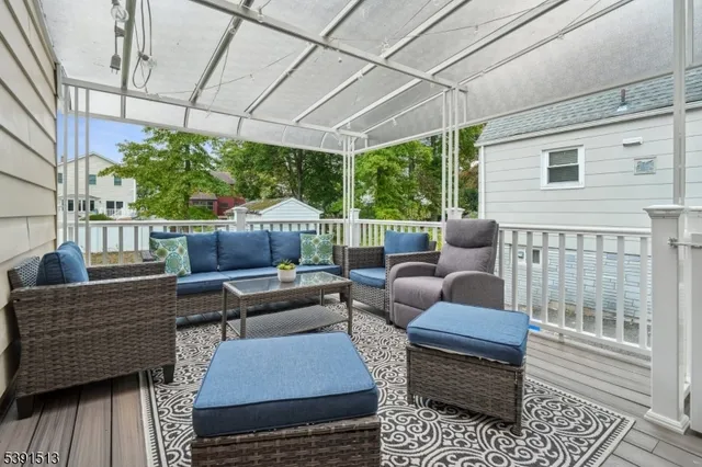 a outdoor living space with patio furniture and a rug
