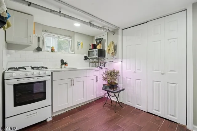 a kitchen with a sink cabinets and wooden floor