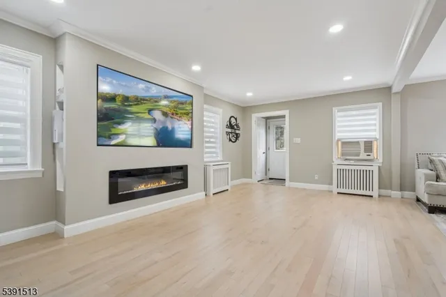 a view of an empty room with window and fire place