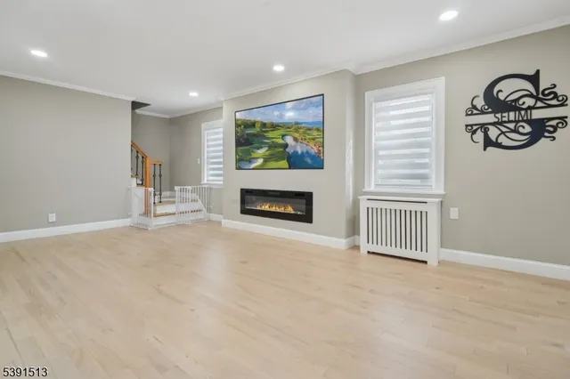 a view of empty room with fireplace and window