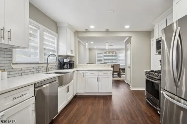 a kitchen with a sink appliances cabinets and a counter top space