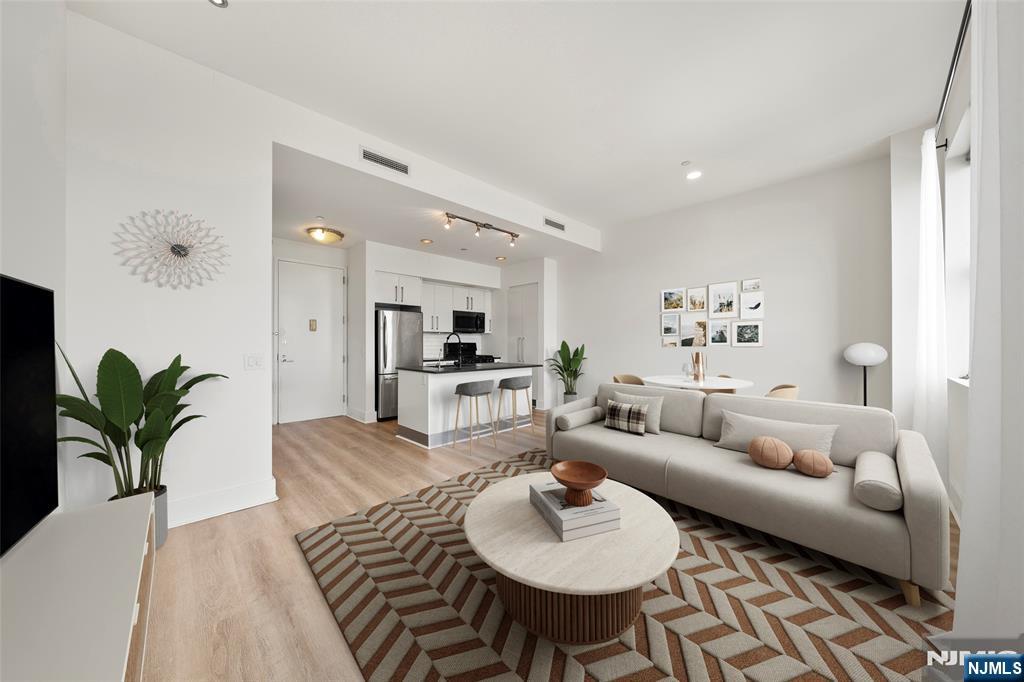 a living room with furniture potted plant and a table