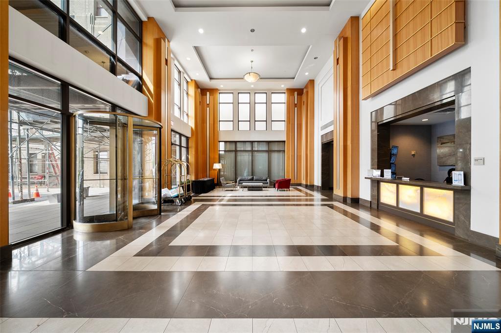 4 Beacon Way, Unit 1407 Jersey City, NJ 07304 - Photo 15 of 19 a view of a living room with a large window
