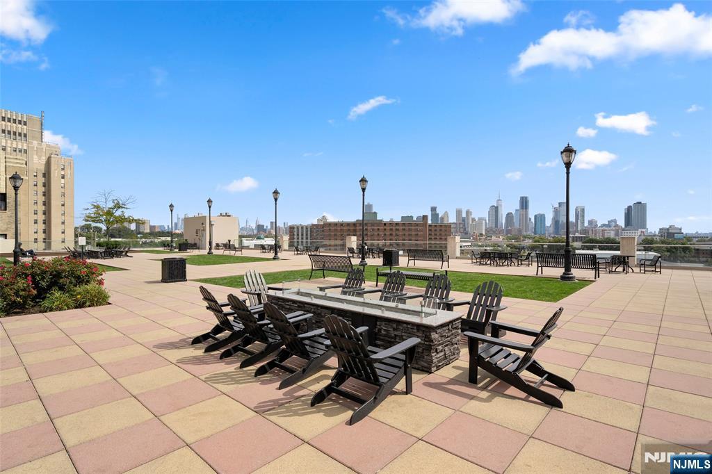 4 Beacon Way, Unit 1407 Jersey City, NJ 07304 - Photo 17 of 19 a view of swimming pool outdoor seating and city view