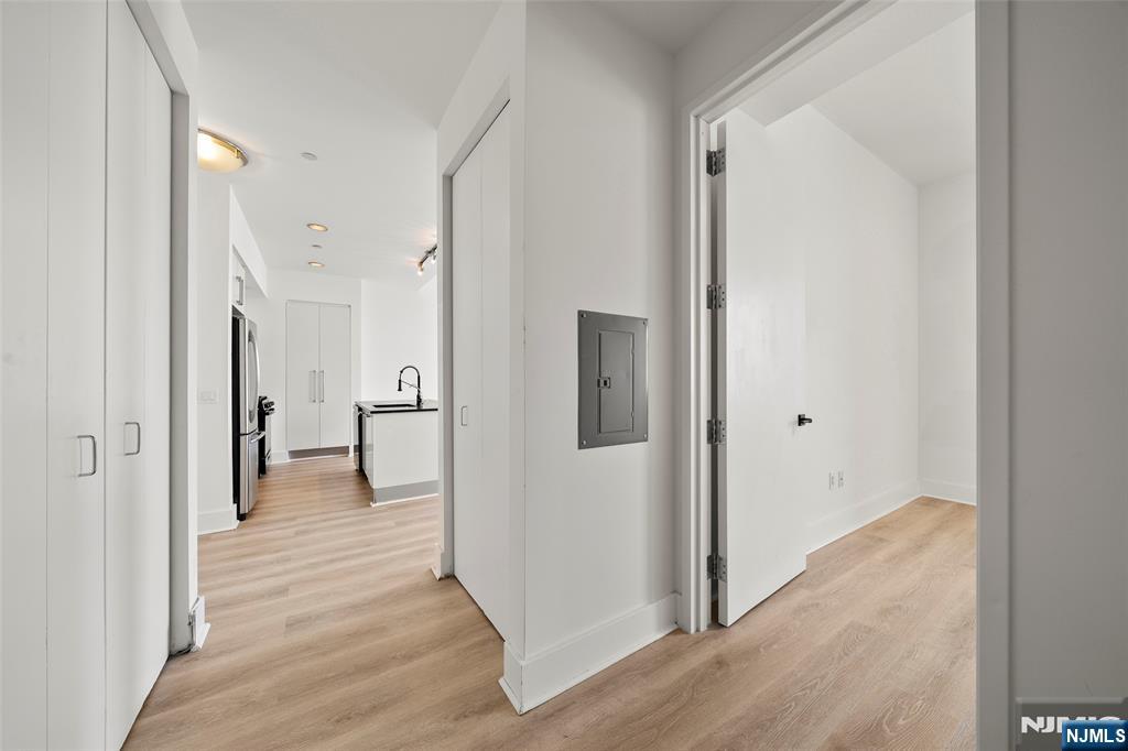 4 Beacon Way, Unit 1407 Jersey City, NJ 07304 - Photo 9 of 19 a view of a hallway with wooden floor
