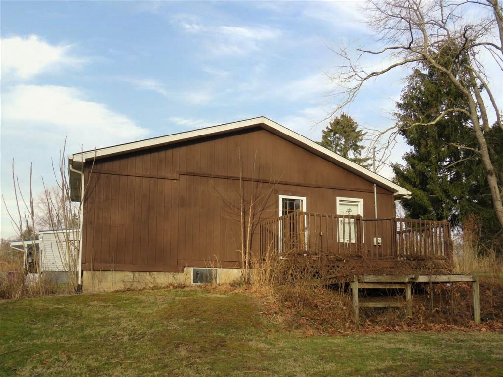 236 Francis Road Pittsburgh, PA 15239 - Photo 3 of 14 a backyard of a house with large trees and outdoor seating