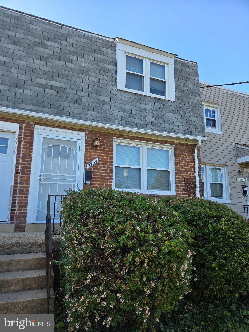 a view of a brick house with a large windows