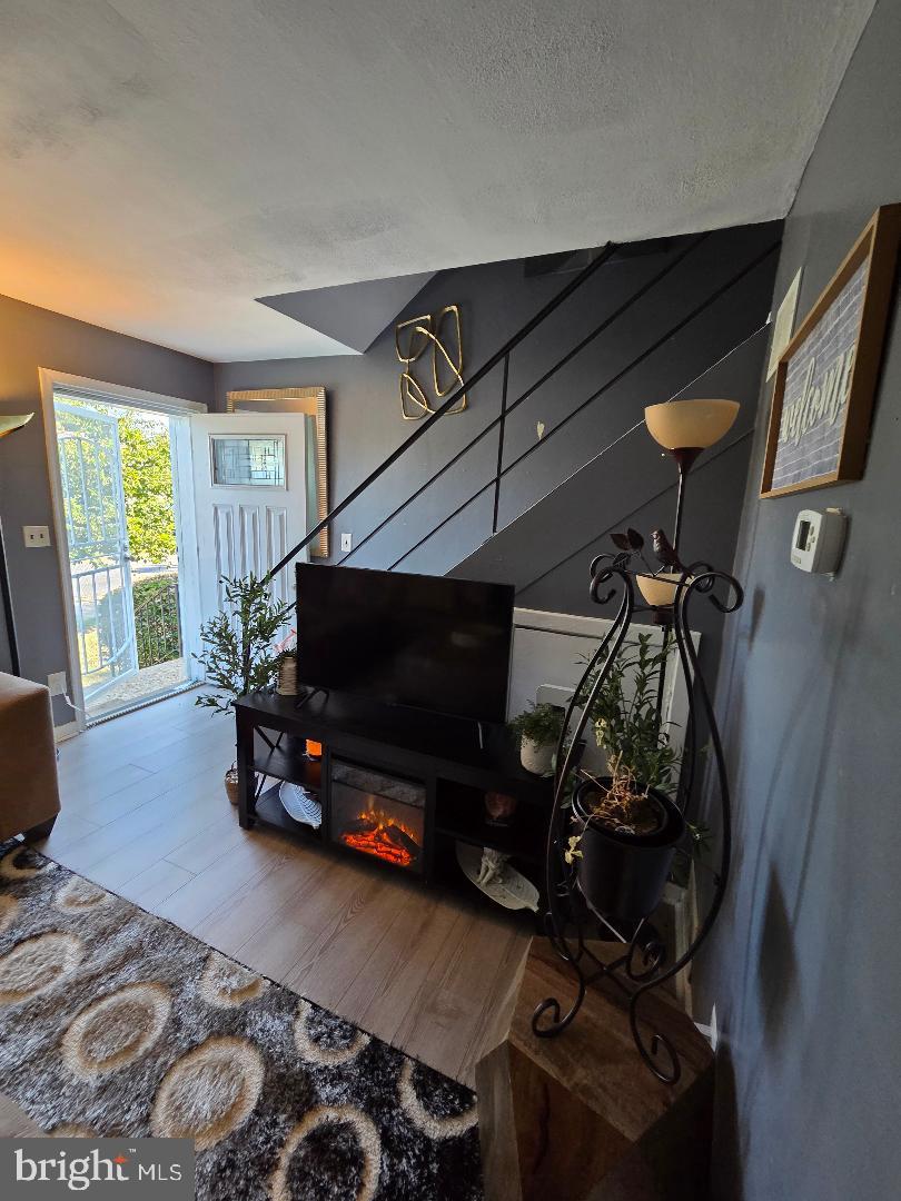 2754 Iverson Street, Unit 72 Temple Hills, MD 20748 - Photo 14 of 17 a living room with furniture and a flat screen tv