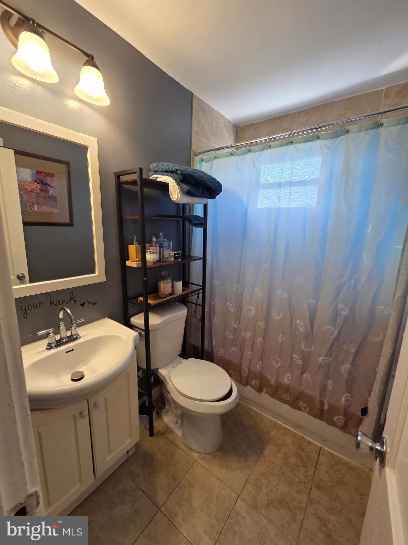 2754 Iverson Street, Unit 72 Temple Hills, MD 20748 - Photo 16 of 17 a bathroom with a sink toilet and shower