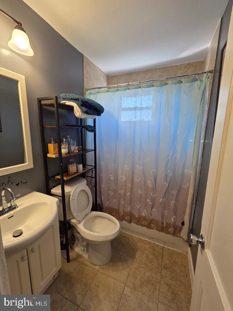 2754 Iverson Street, Unit 72 Temple Hills, MD 20748 - Photo 6 of 17 a bathroom with a sink a toilet a mirror and shower
