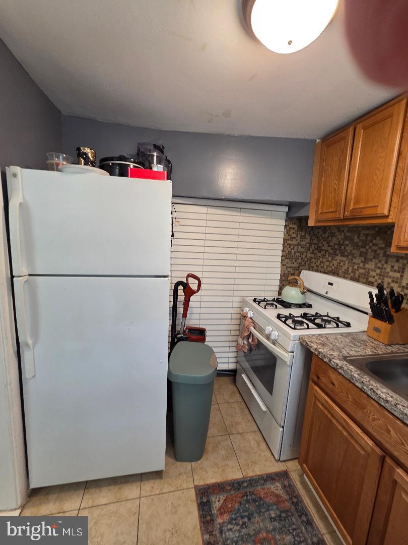 2754 Iverson Street, Unit 72 Temple Hills, MD 20748 - Photo 9 of 17 a kitchen with a refrigerator and a stove