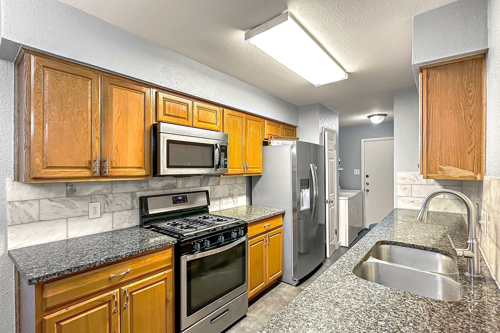 700 Misty Morning Way Round Rock, TX 78664 - Photo 8 of 36 Unit B - A well-appointed kitchen features ample cabinetry, granite counters, and stainless steel appliances.