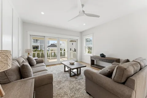 a living room with furniture a fireplace and a chandelier