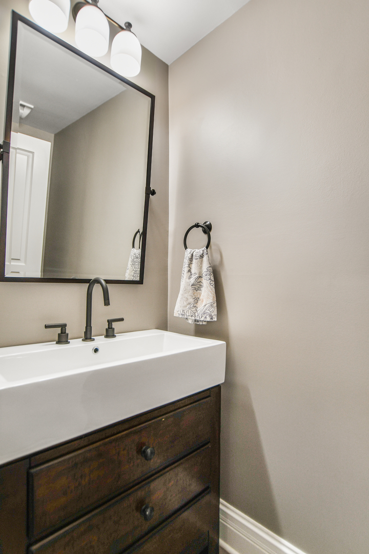 2224 North Wayne Avenue Chicago, IL 60614 - Photo 13 of 36 a bathroom with a sink and a mirror