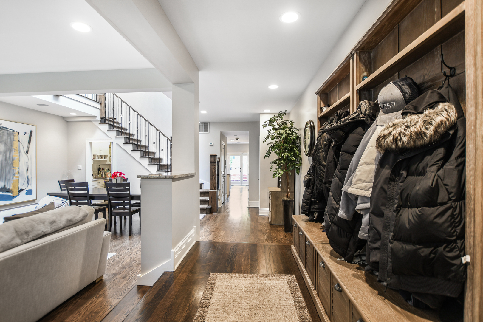 2224 North Wayne Avenue Chicago, IL 60614 - Photo 3 of 36 a hallway with white cabinets and couches with wooden floor