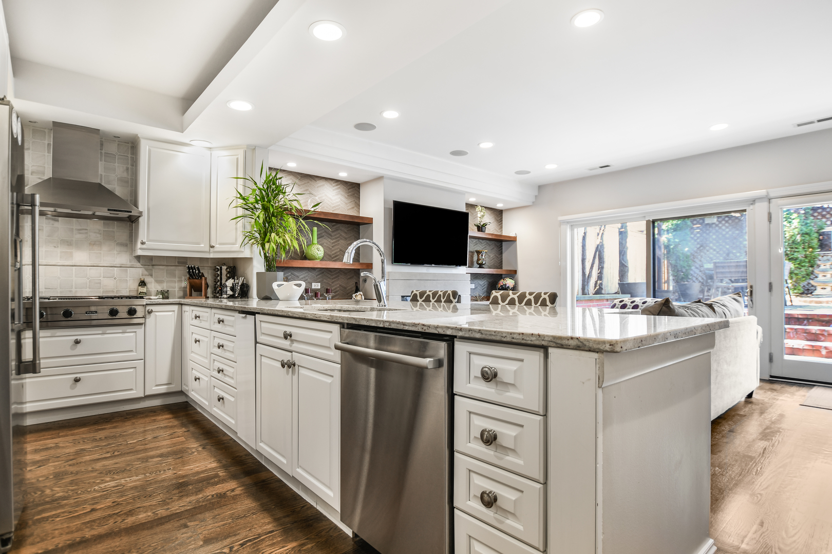 2224 North Wayne Avenue Chicago, IL 60614 - Photo 10 of 36 a kitchen with stainless steel appliances kitchen island granite countertop a sink and cabinets