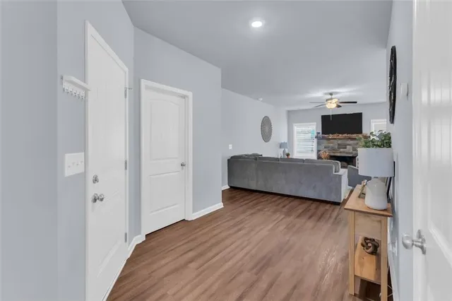 a living room with a bed furniture and a flat screen tv