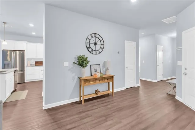 a view of a hallway with wooden floor