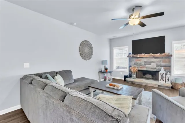 a living room with furniture a fireplace and a flat screen tv