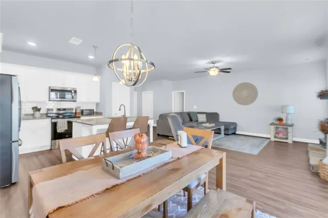 a living room with lots of furniture and kitchen view