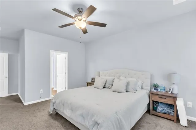 a bedroom with a bed and a ceiling fan