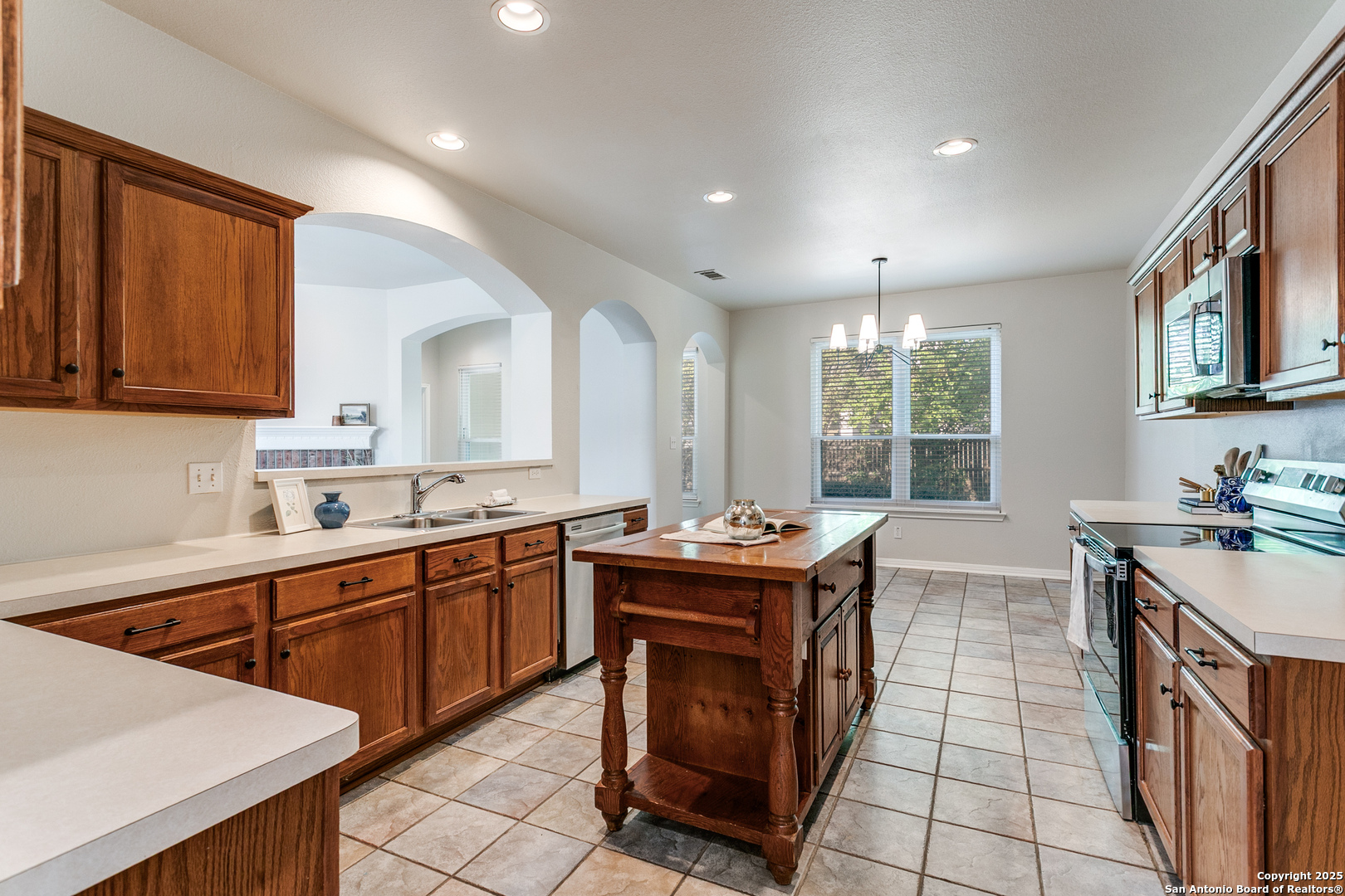 112 Spring Fawn Cibolo, TX 78108 - Photo 13 of 26 a kitchen that has a sink a stove and chairs in it