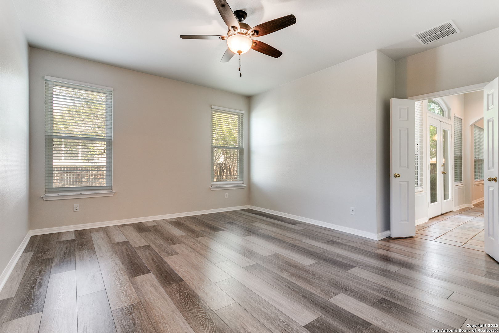 112 Spring Fawn Cibolo, TX 78108 - Photo 16 of 26 wooden floor in an empty room with a window