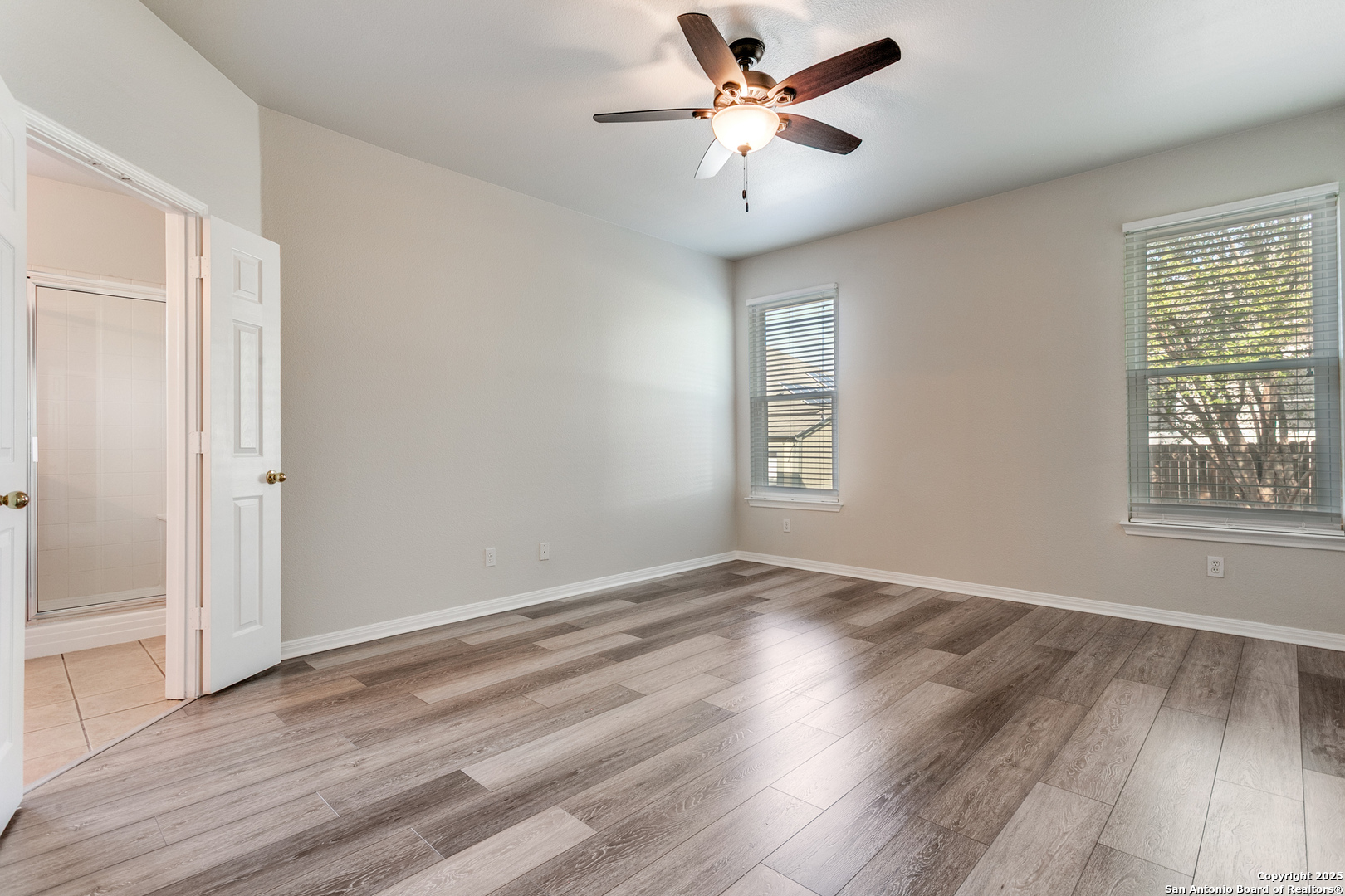 112 Spring Fawn Cibolo, TX 78108 - Photo 17 of 26 an empty room with wooden floor fan and windows