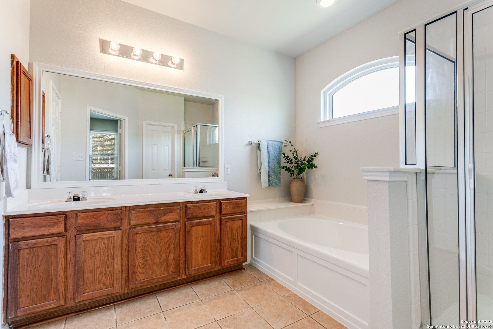 112 Spring Fawn Cibolo, TX 78108 - Photo 18 of 26 a spacious bathroom with a tub sink and mirror